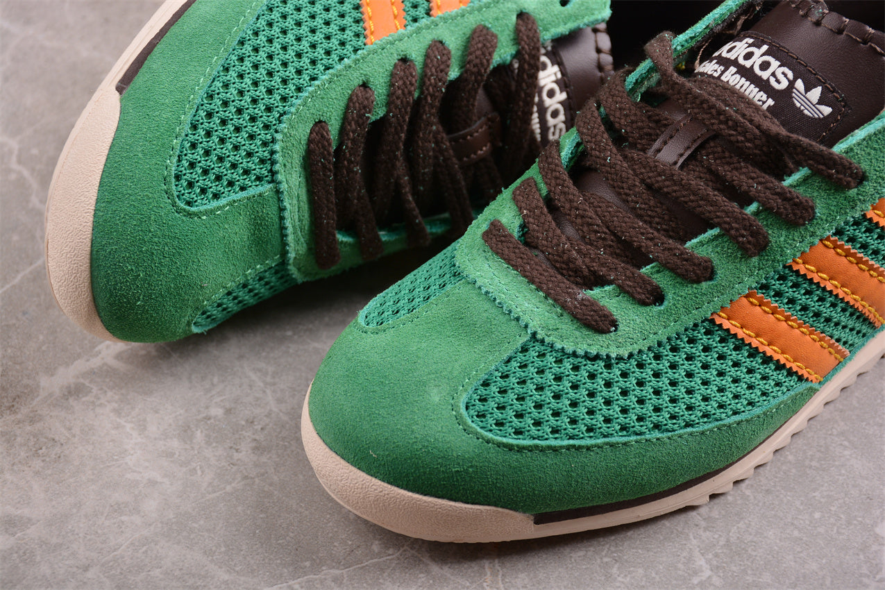 Green Adidas sneakers with orange accents 