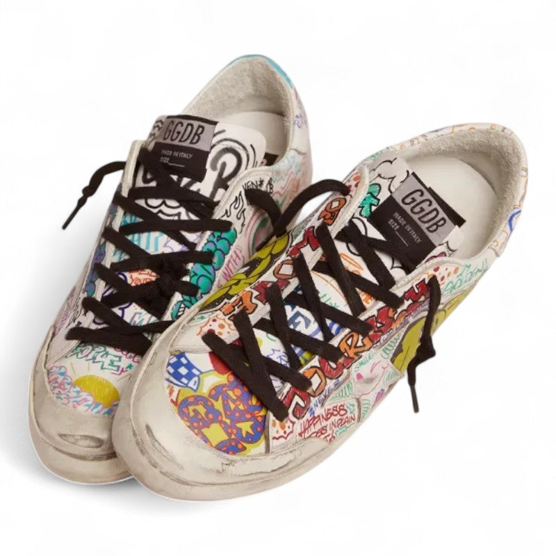 The Super-Star sneakers feature a white leather upper adorned with a vibrant multicolored graffiti print - Best Reps Website 2025